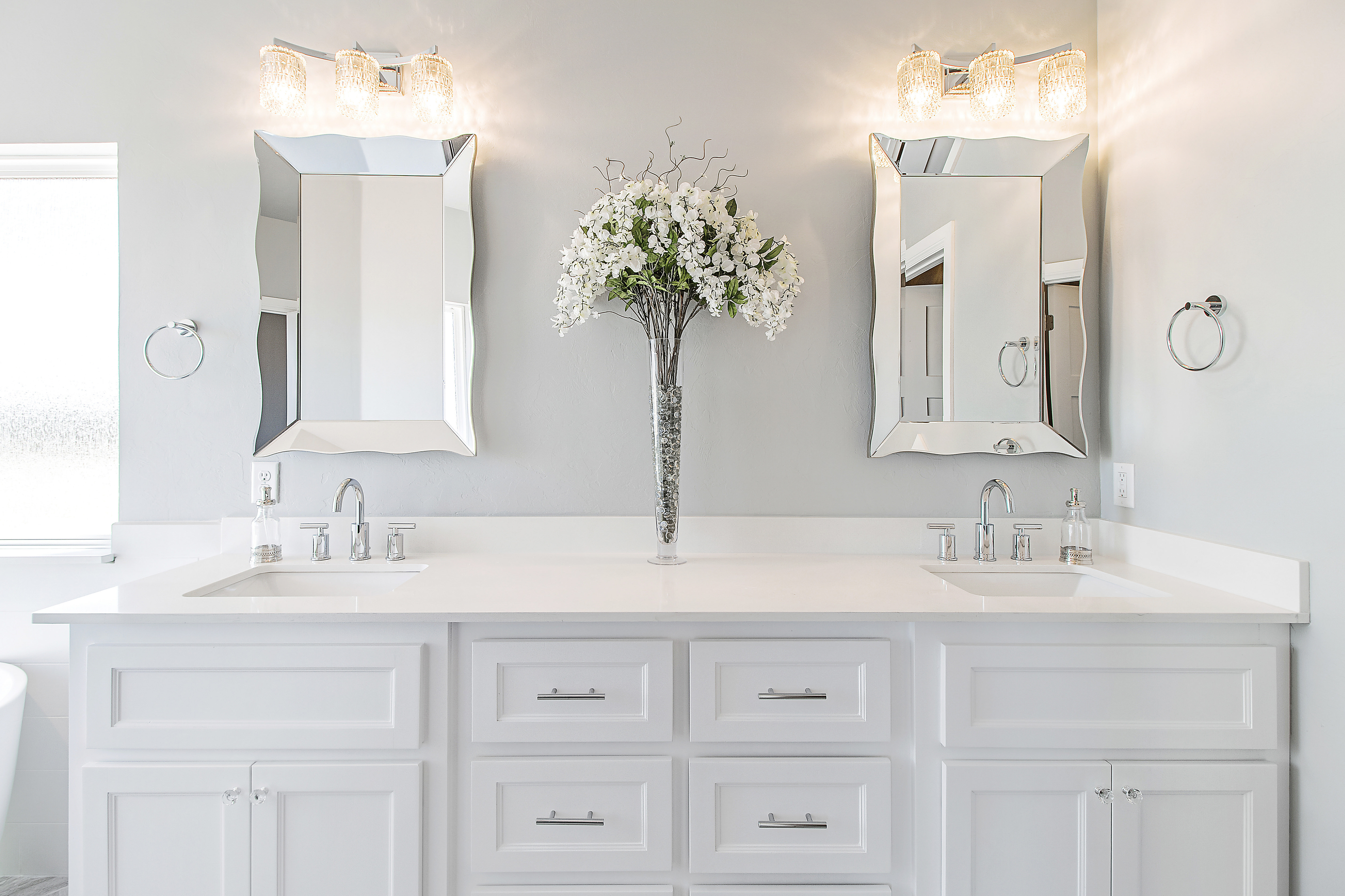 This bathroom makeover uses neutral cabinets and accents to improve the overall look and feel