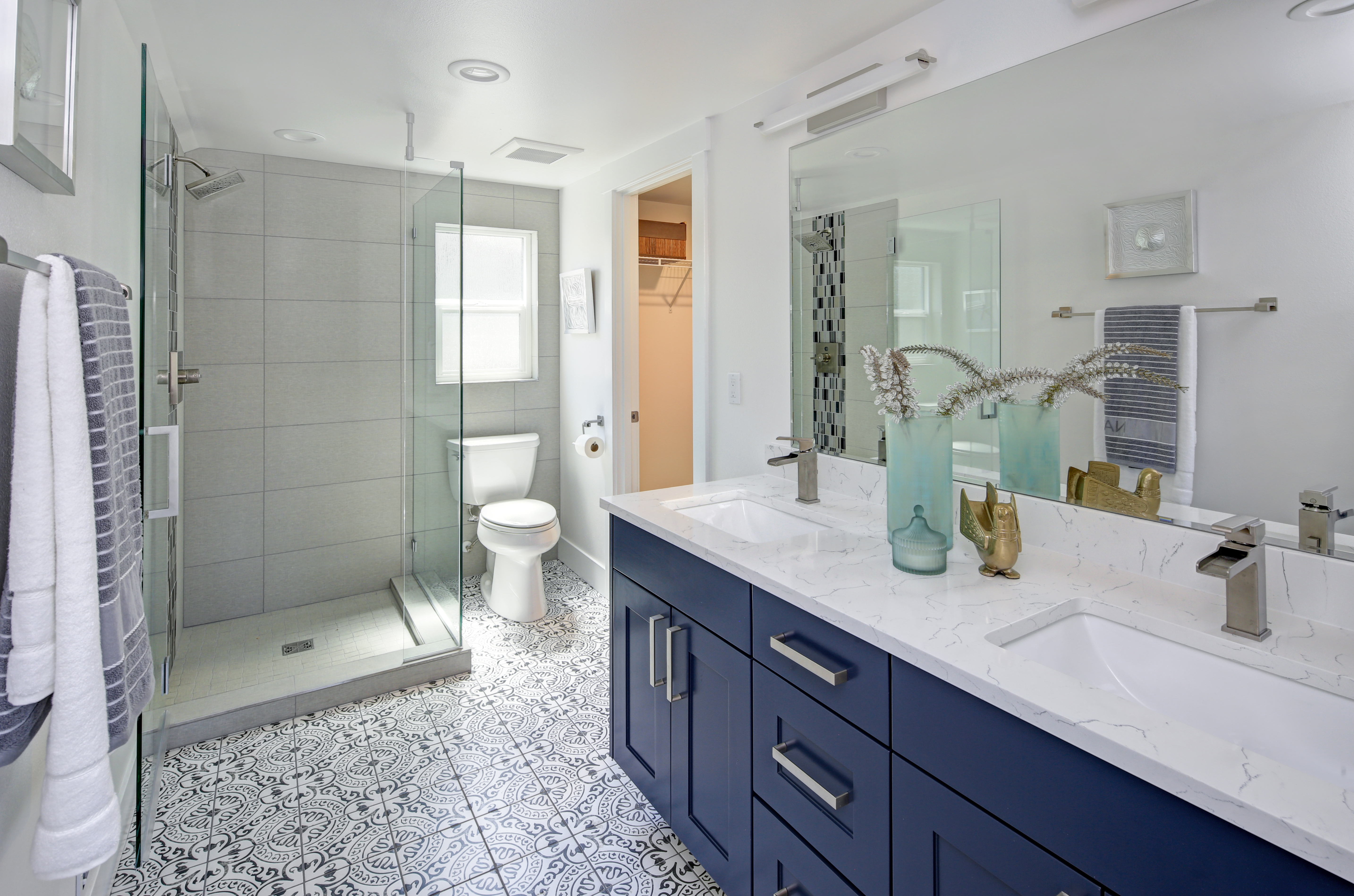 This luxury bathroom features a strong bath and bright white porcelain for an open look