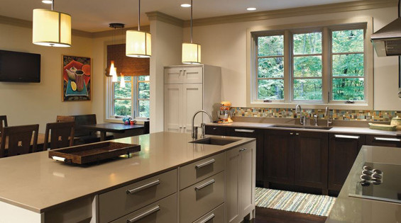 Soft lighting fixtures combine with an updated kitchen restoration with bold artwork and backsplash