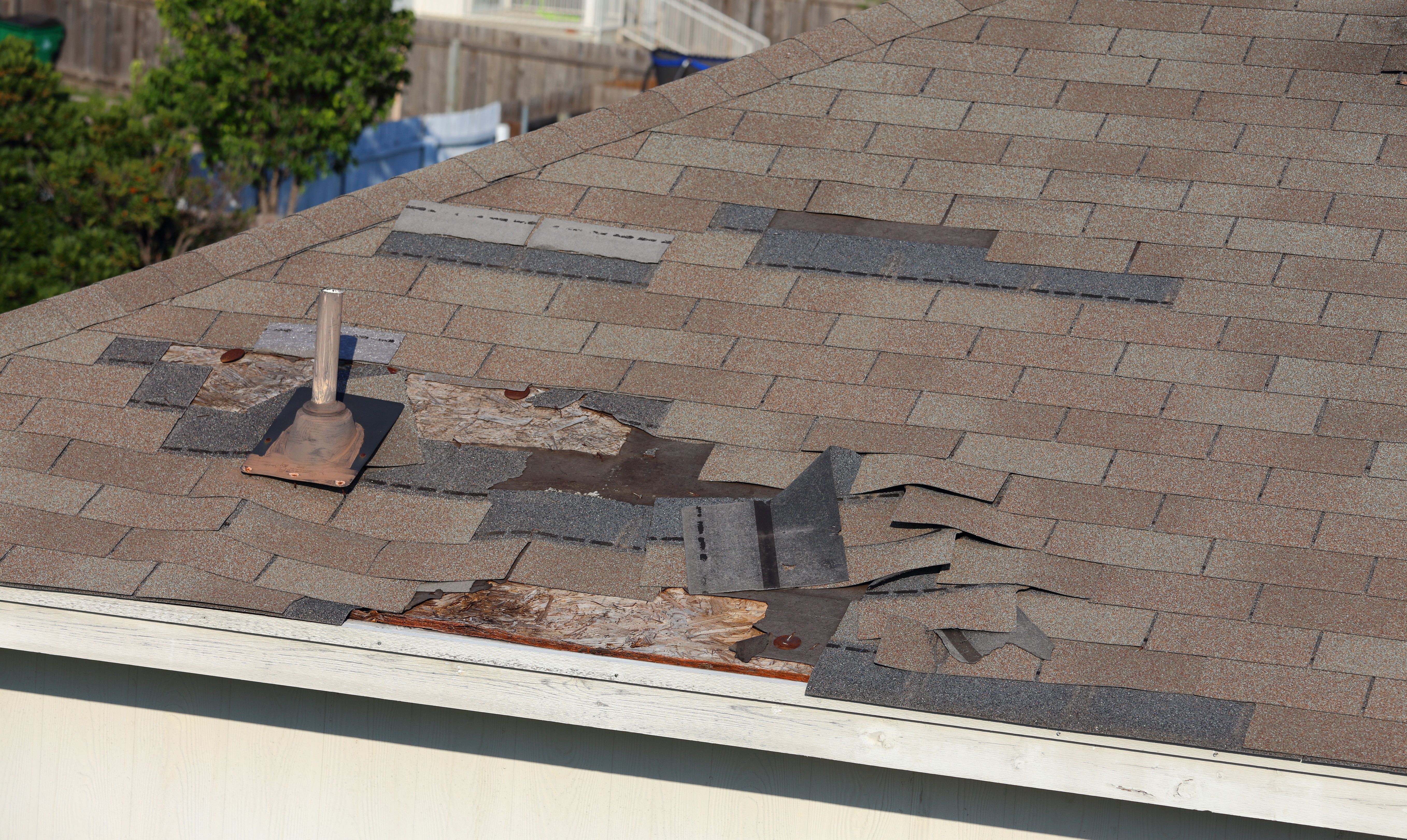 Mosaic-style roofing shingles top off this beige stucco home